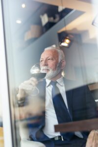Senior businessman drinking wine in a restaurant