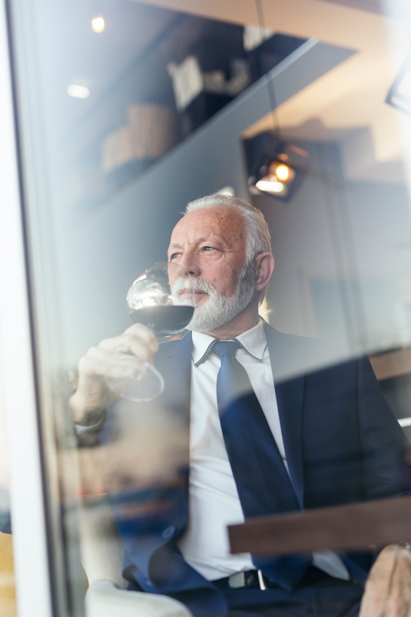 Senior businessman drinking wine in a restaurant