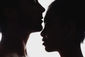 side view of silhouettes of interracial couple in love