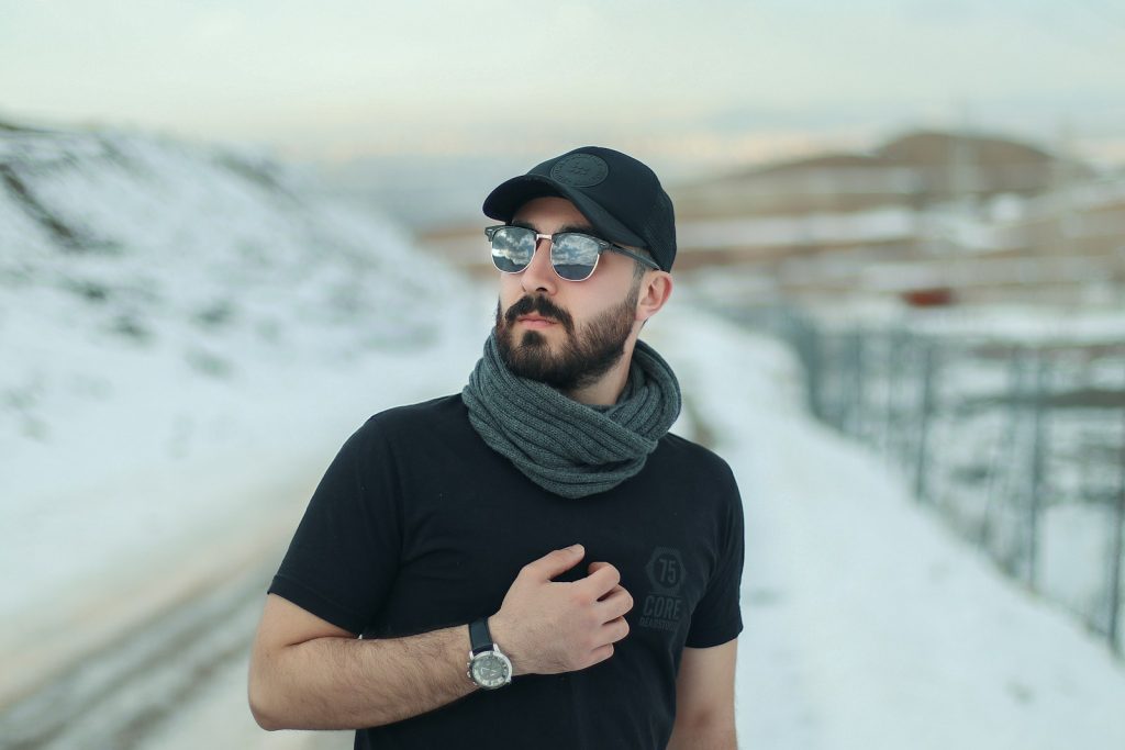 a man with a beard wearing sunglasses and a scarf